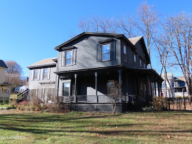 exterior space featuring covered porch and a front yard