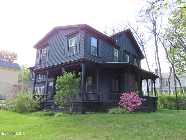 rear view of property with a porch and a yard