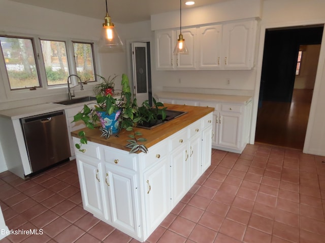 kitchen with pendant lighting, white cabinetry, stainless steel dishwasher, and sink