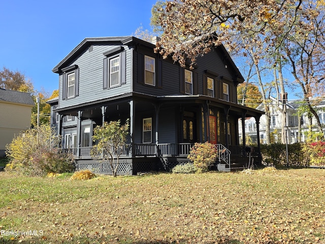 view of front of home with covered porch and a front yard