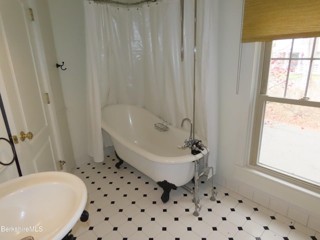 bathroom featuring sink and a bath