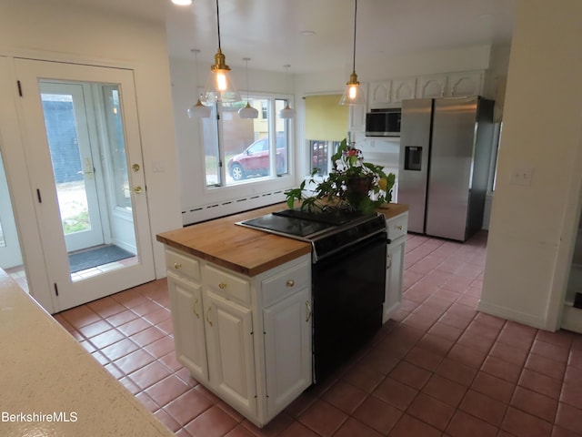 kitchen with stainless steel fridge, black range with electric cooktop, butcher block countertops, white cabinetry, and tile patterned flooring