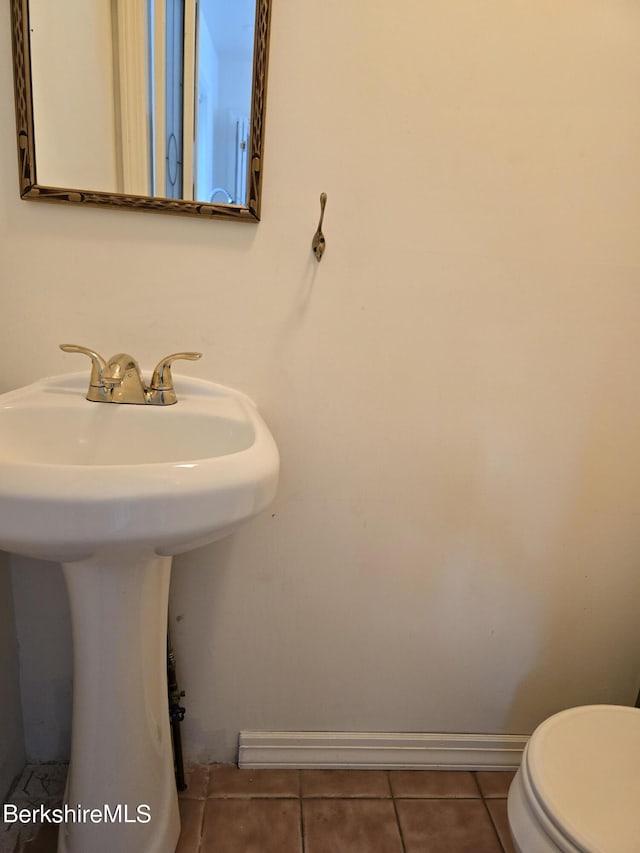 bathroom featuring tile patterned floors, toilet, and sink