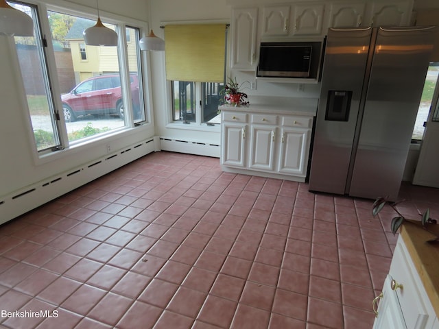 kitchen with pendant lighting, white cabinetry, stainless steel fridge with ice dispenser, and built in microwave