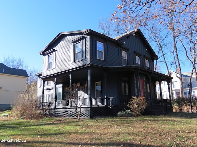 view of front facade featuring covered porch and a front lawn