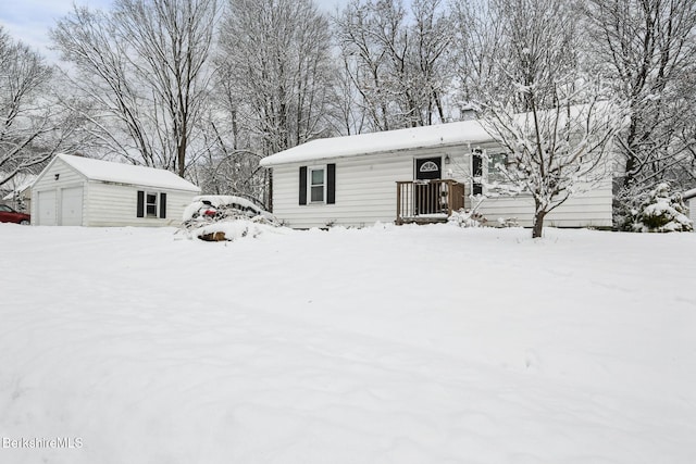 view of front facade with an outbuilding and a garage