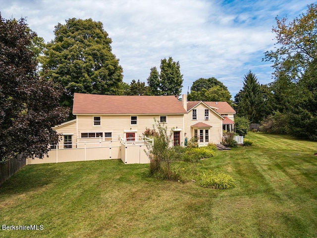 rear view of house with a yard