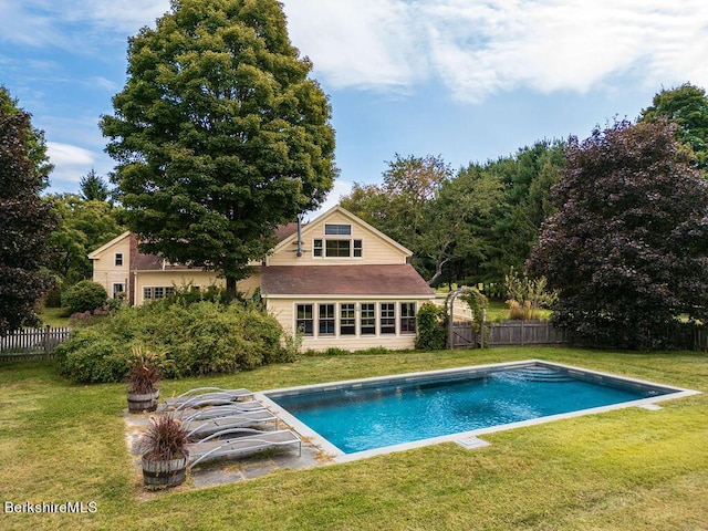 view of swimming pool with a lawn