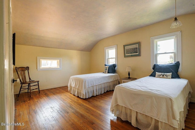 bedroom featuring hardwood / wood-style flooring and lofted ceiling