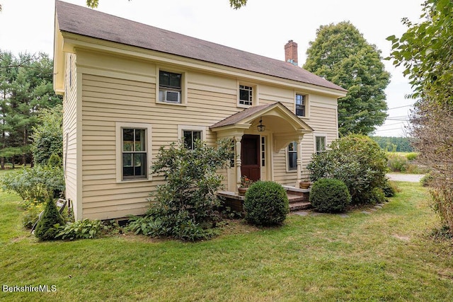 colonial-style house with a front lawn