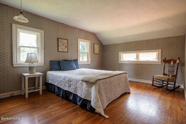 bedroom featuring wood-type flooring and vaulted ceiling