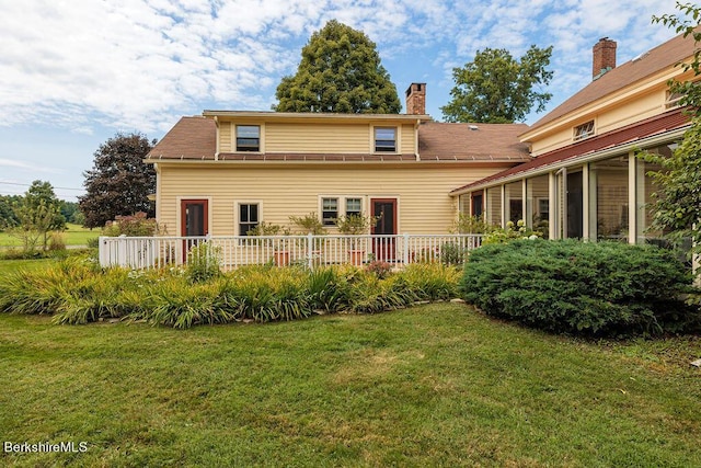 back of house with a yard