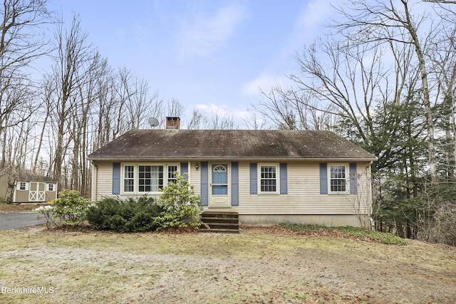 view of front of house featuring a shed