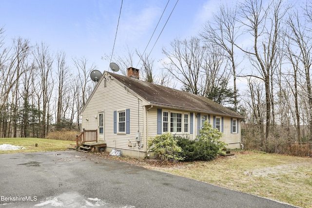 view of property exterior featuring a lawn