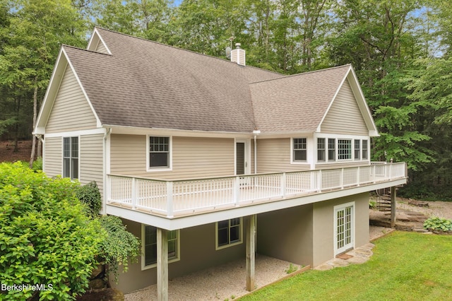 2017 Monterey Rd, Otis, MA 01253 - back of property featuring a wooden deck, a shingled roof, a chimney, and a yard