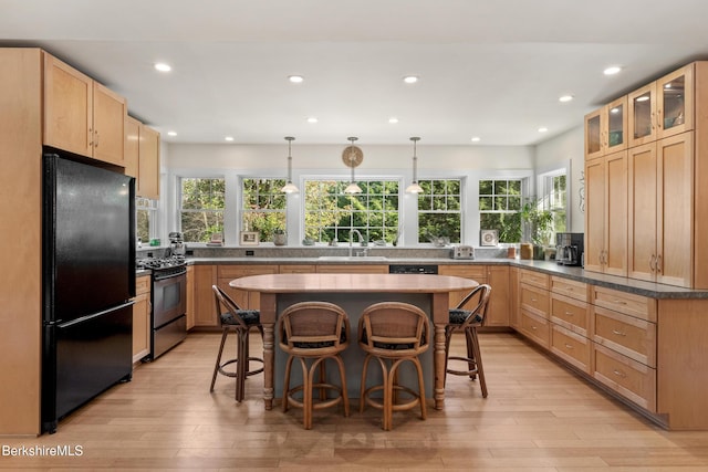 2017 Monterey Rd, Otis, MA 01253 - kitchen featuring freestanding refrigerator, stainless steel gas range, recessed lighting, a breakfast bar, and light wood-type flooring
