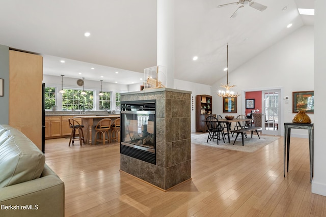 2017 Monterey Rd, Otis, MA 01253 - kitchen with high vaulted ceiling, ceiling fan, a fireplace, recessed lighting, and a kitchen breakfast bar
