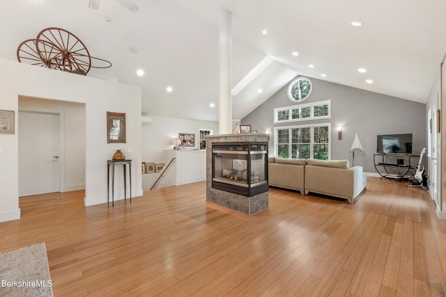 2017 Monterey Rd, Otis, MA 01253 - living room featuring high vaulted ceiling, a multi sided fireplace, light wood-type flooring, and recessed lighting