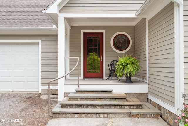 2017 Monterey Rd, Otis, MA 01253 - view of exterior entry featuring a shingled roof, a garage, and covered porch