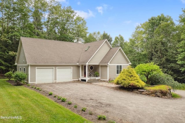 2017 Monterey Rd, Otis, MA 01253 - view of front of home featuring a garage, driveway, a shingled roof, and a front lawn