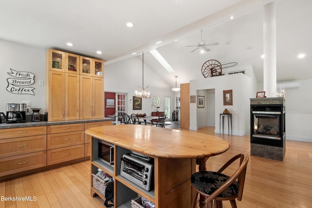 2017 Monterey Rd, Otis, MA 01253 - kitchen with a breakfast bar, light wood finished floors, beamed ceiling, a chandelier, and a multi sided fireplace