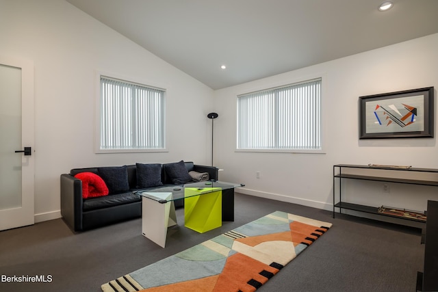 living room with a healthy amount of sunlight and vaulted ceiling