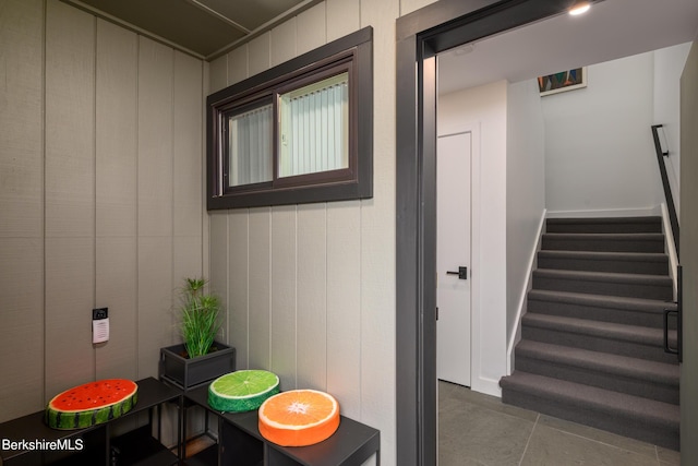 stairway featuring tile patterned flooring