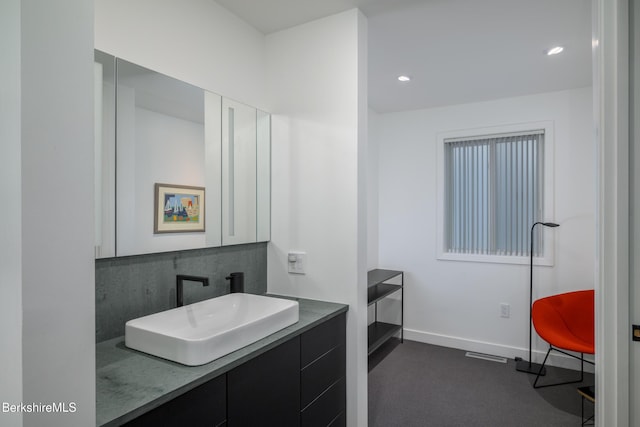 bathroom featuring backsplash and vanity