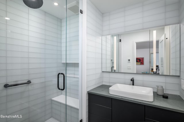 bathroom featuring tasteful backsplash, vanity, and walk in shower