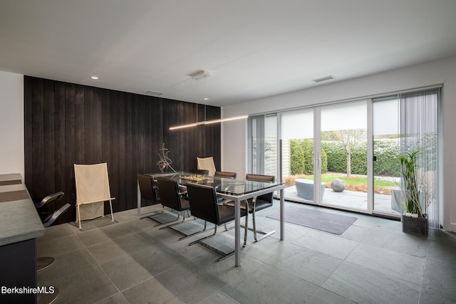 dining room with wooden walls