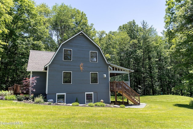 view of side of property with a yard, roof with shingles, stairs, and a gambrel roof