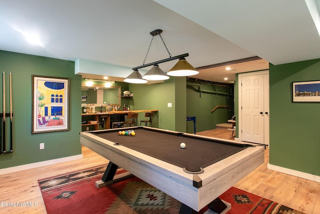 recreation room with light wood finished floors, indoor wet bar, billiards, and baseboards