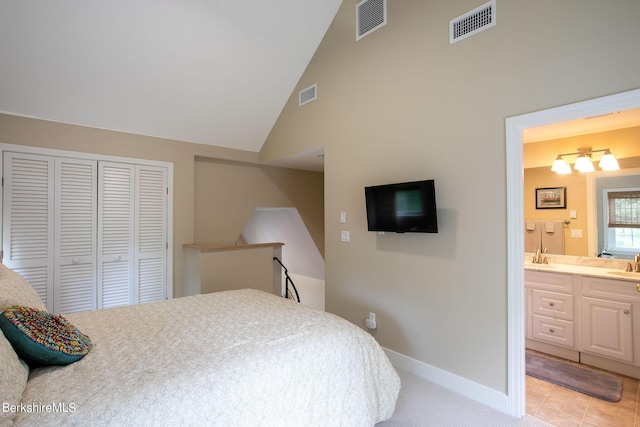 bedroom featuring ensuite bath, baseboards, visible vents, and a closet