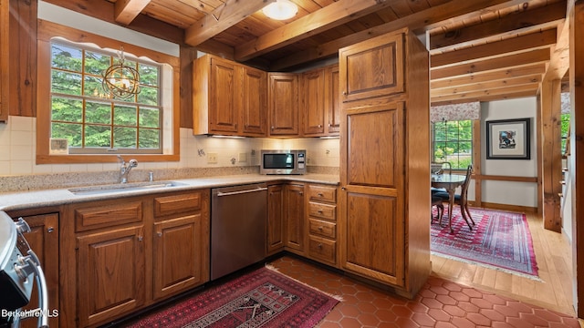 51 New Lenox Rd, Lenox, MA 01240 - kitchen with appliances with stainless steel finishes, a wooden ceiling with exposed beams, brown cabinets, decorative backsplash, and light countertops