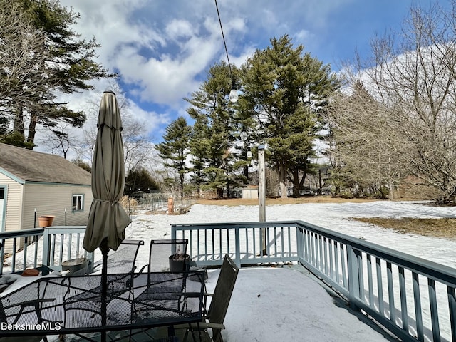 snow covered deck with a patio