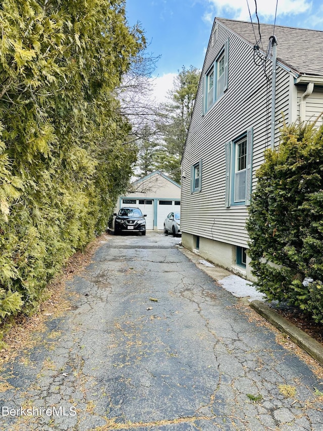 view of side of property featuring a garage and an outdoor structure