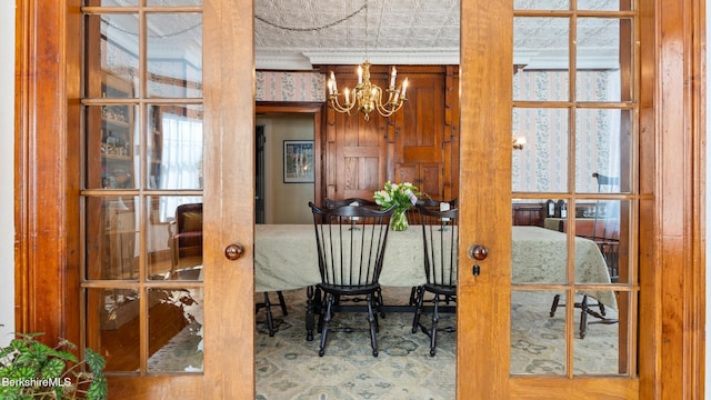 dining room with a notable chandelier and french doors