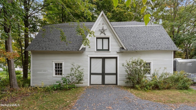 view of front of house featuring roof with shingles