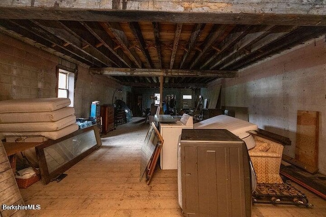 basement with washer / dryer and light hardwood / wood-style flooring