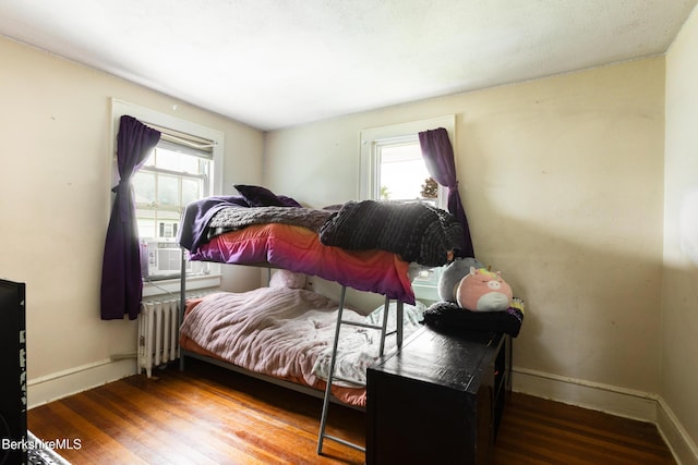 30 Belvidere Ave, Pittsfield, MA 01201 - bedroom featuring radiator heating unit, multiple windows, wood finished floors, and cooling unit