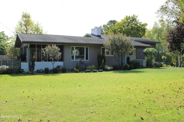 ranch-style house with a sunroom and a front lawn