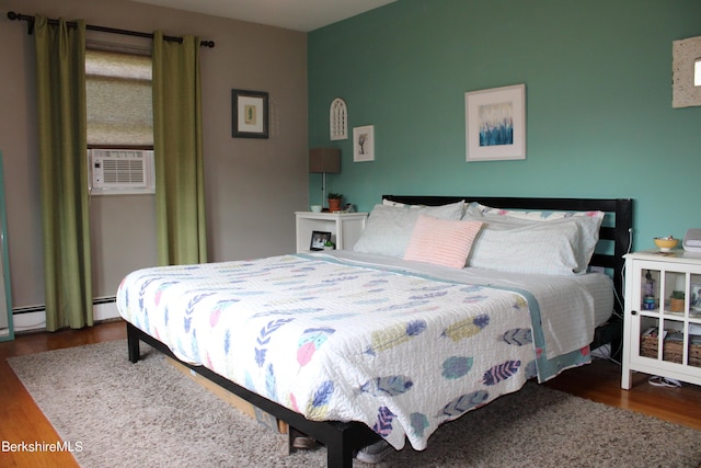 bedroom with dark hardwood / wood-style flooring, cooling unit, and a baseboard radiator