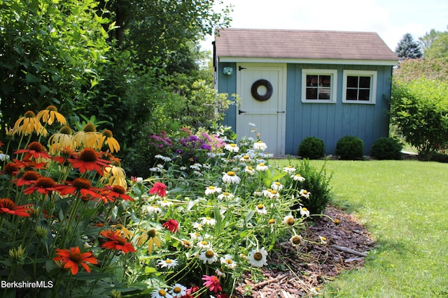 view of outdoor structure featuring a lawn