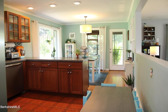 kitchen with crown molding, dishwasher, and decorative light fixtures