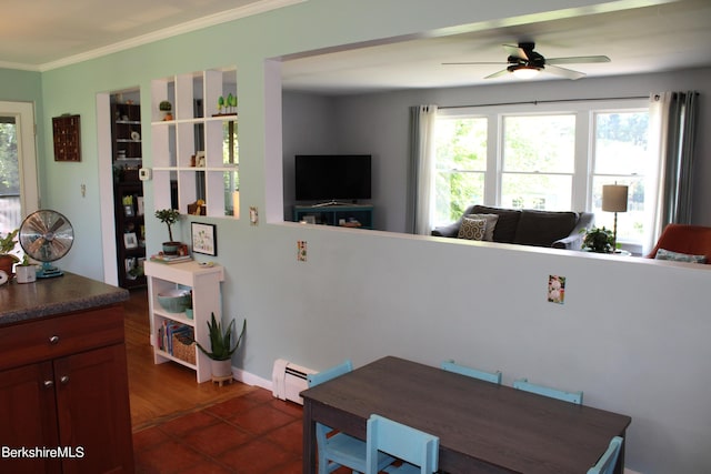 tiled dining space with a baseboard radiator, ceiling fan, and ornamental molding