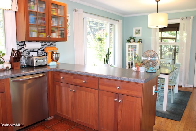 kitchen with kitchen peninsula, backsplash, crown molding, decorative light fixtures, and dishwasher