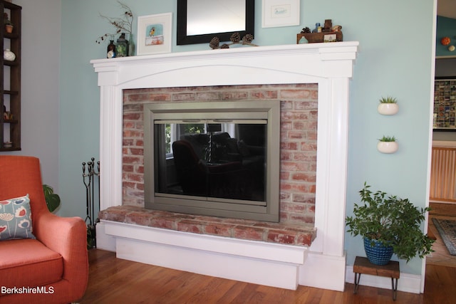 room details with hardwood / wood-style flooring and a fireplace