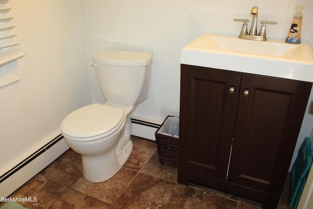 bathroom with vanity, toilet, and baseboard heating