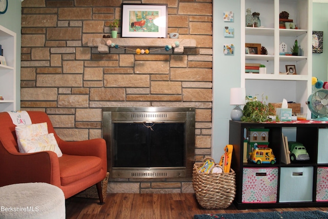 living room featuring dark hardwood / wood-style floors and a fireplace