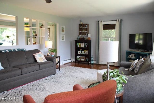 living room with dark wood-type flooring and a baseboard radiator